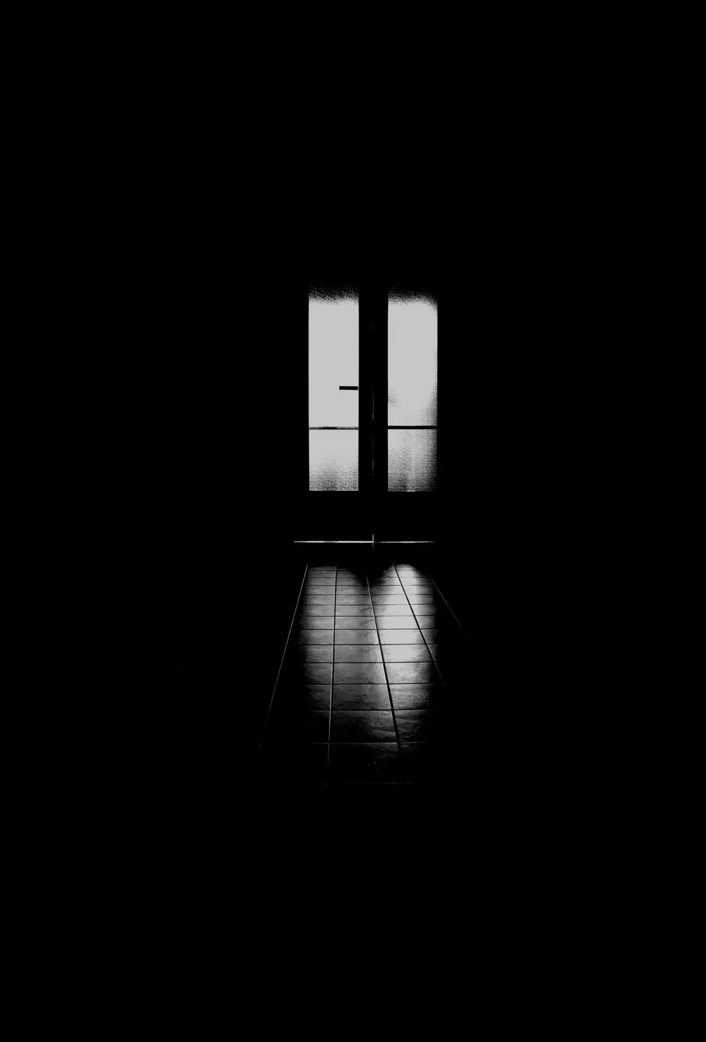 Light falling through an open doorway into a dark room