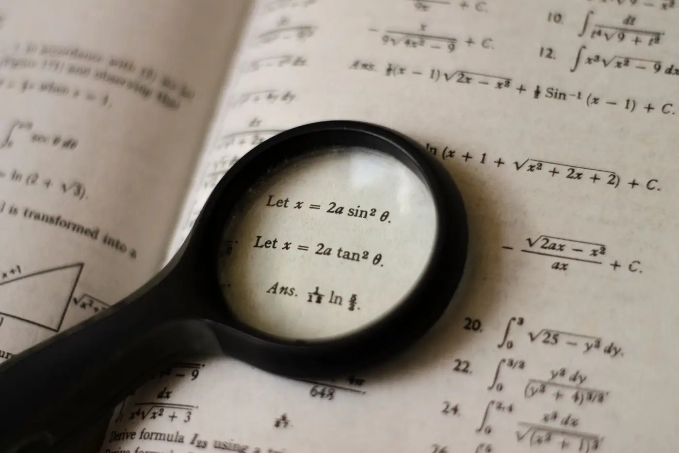 A magnifying glass over a page of equations