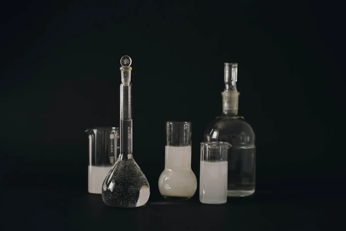 Laboratory glassware on a dark bench